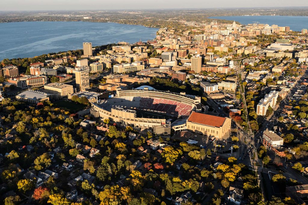 Ariel View Over Camp Randall Stadium. Near side the picture shows tree and at the far side of the picture shows two lakes coming together at the Isthmus.
