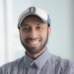 SameerDeshpande_headshot Centered is Dr. Sameer Deshpande. Sameer is wearing a baseball hat and a checkered colored shirt