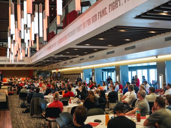 More than 200 coaches and leaders seated at round tables inside Camp Randall Stadium for the 2026 BIOS Leadership and Coaching Symposium.